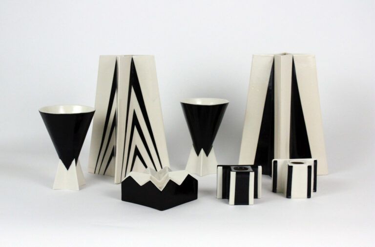 A seres of ceramic black and white sculptures on a white table