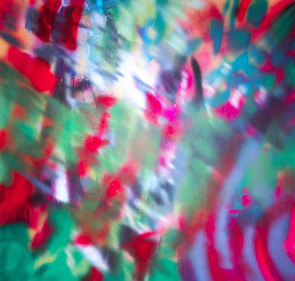 An abstract image in red, purple, green, blue and white