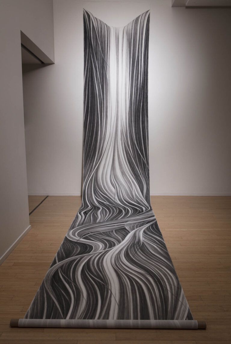 A long scroll of paper with a drawing of flowing abstract strands