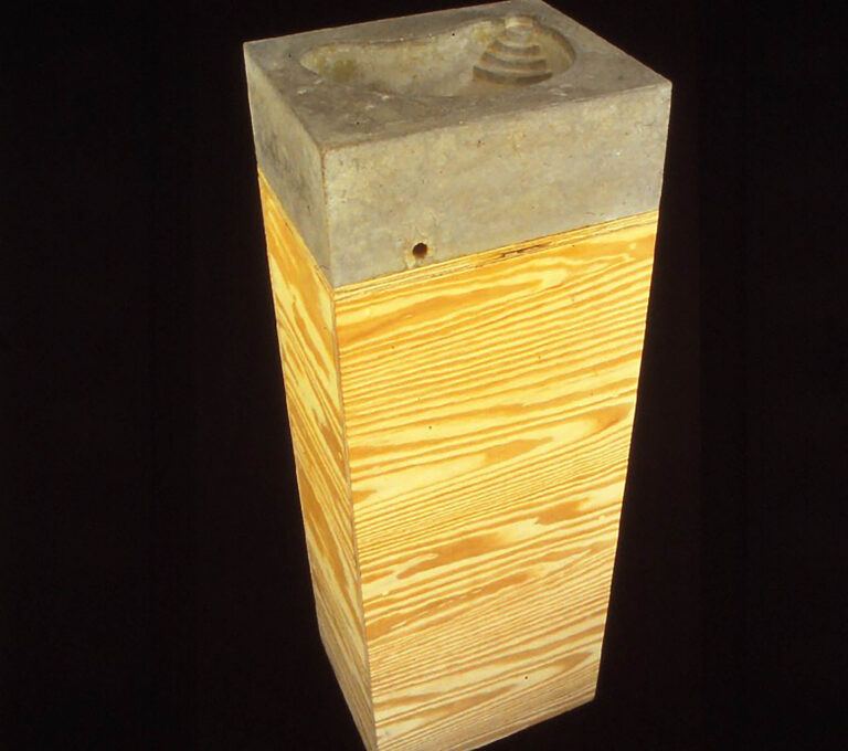 A rectangular sculpture made of wood and stone