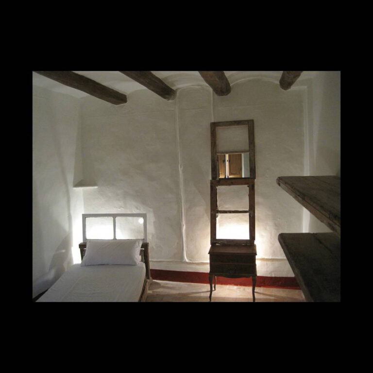A bedroom interior with stucco walls