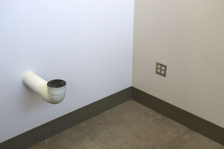 A drain installed in a gallery wall