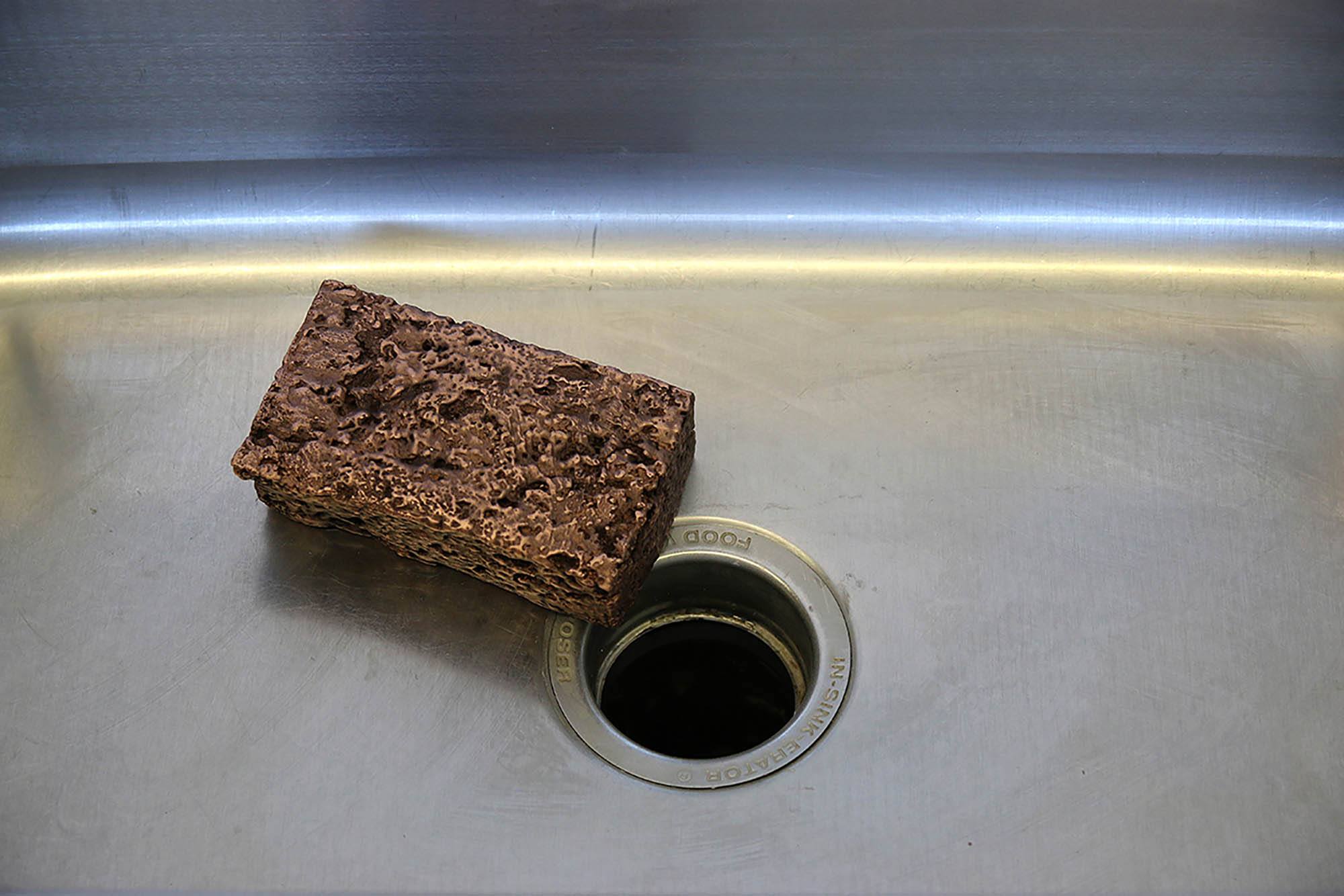 A sponge in an empty metal sink