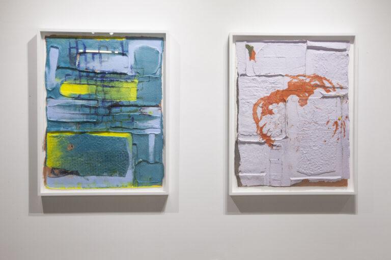 Two abstract paintings hung beside one another