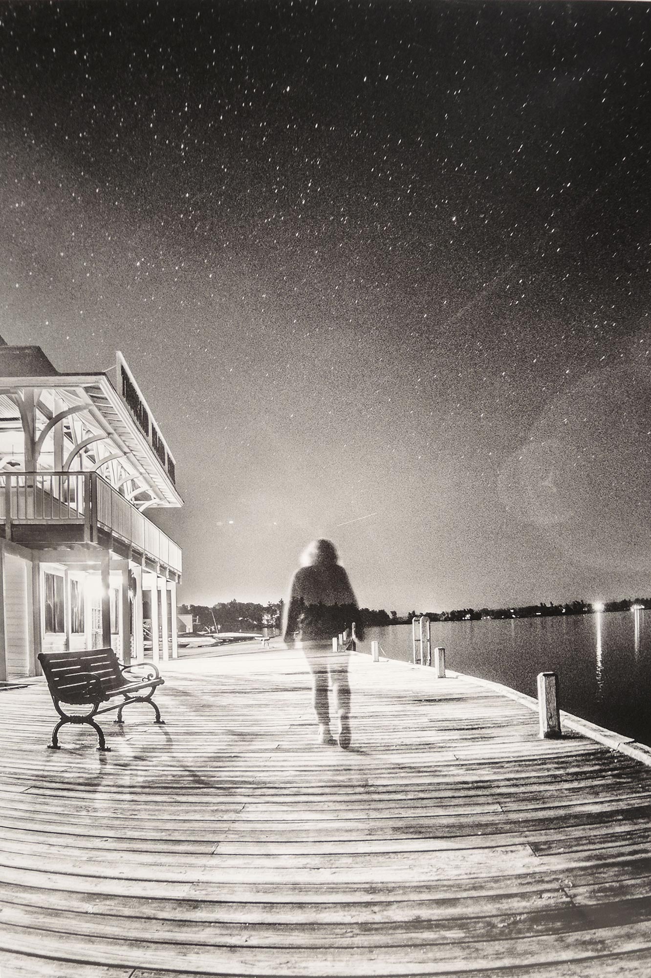 A photograph by Gabrielle Robinson of a person walking away from the camera on a starry night