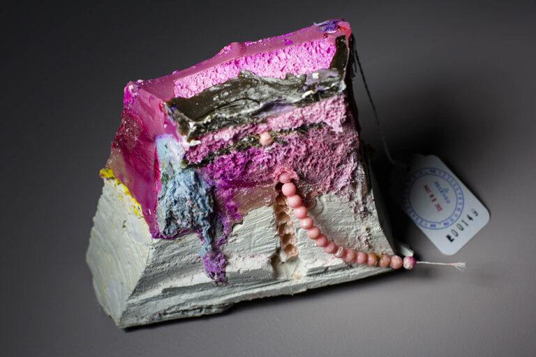 A cross section of a sculpture of layered colored materials