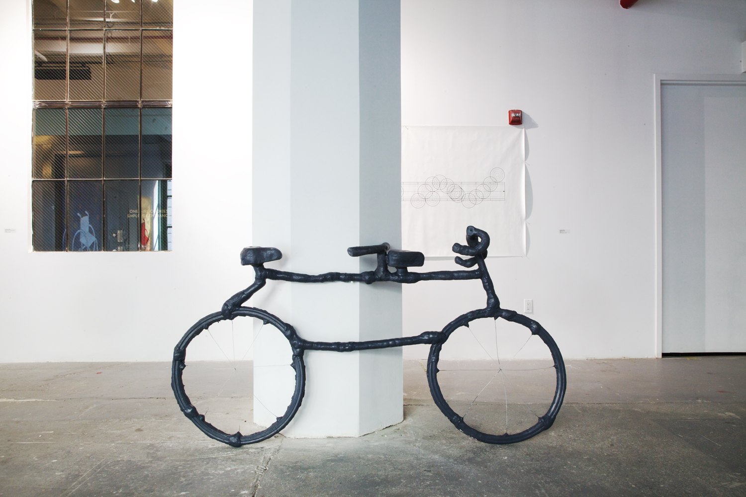 Installation image containing a sculpture of a bike