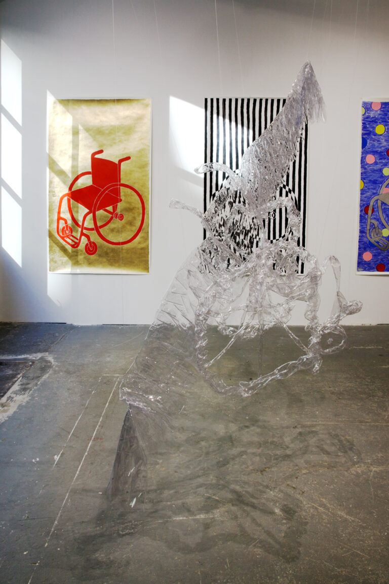 Installation image containing a large suspended clear sculpture