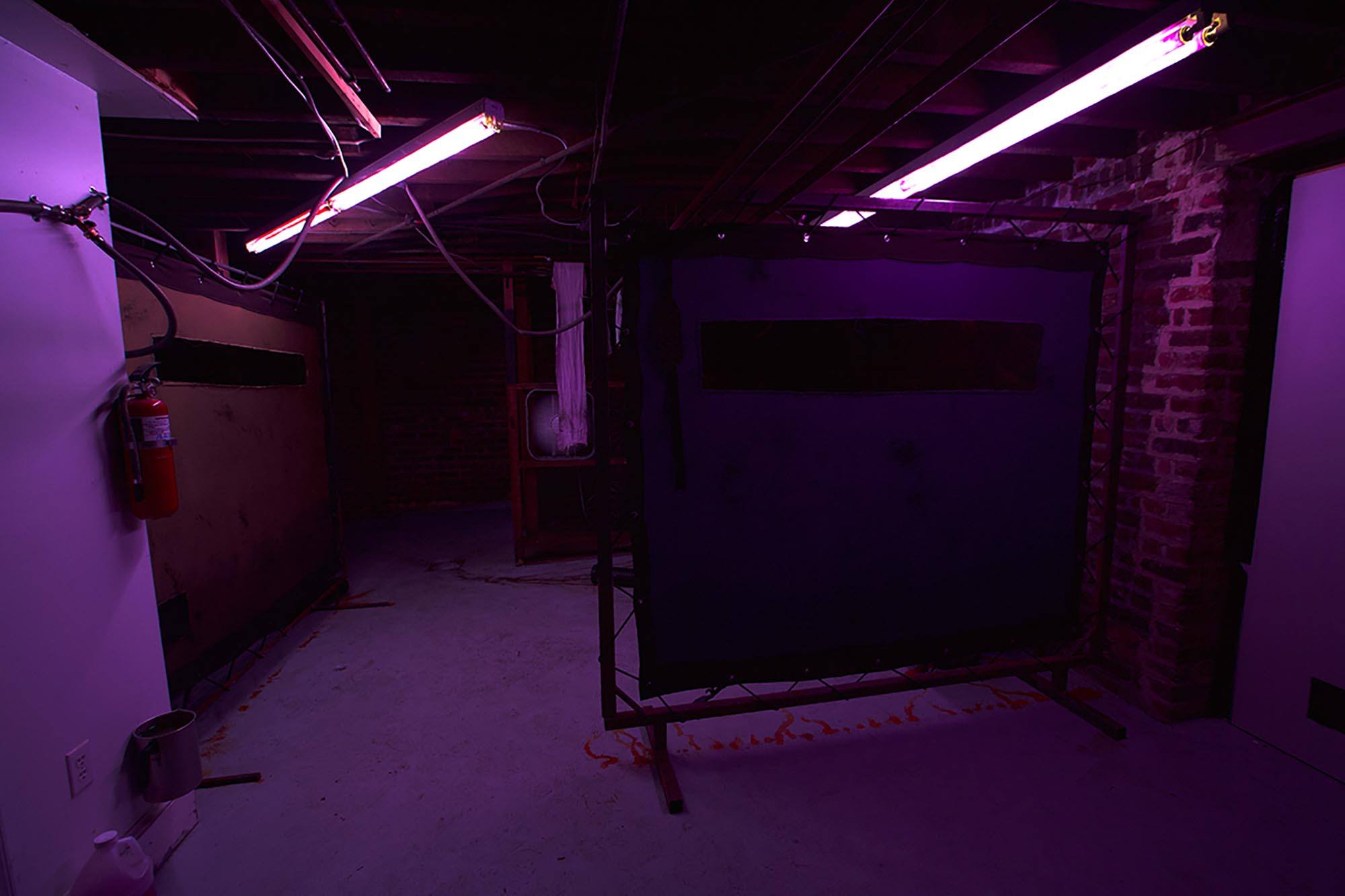 A purple illuminated unfinished room