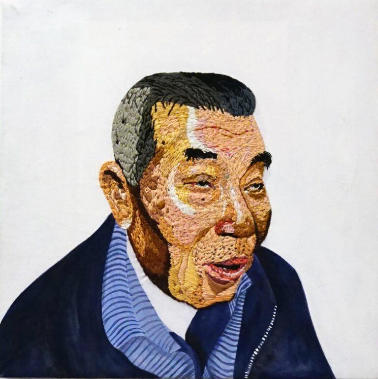 An embroidered portrait of a man