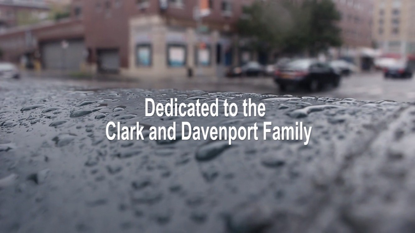 A photograph of rainwater on a surface with the text "Dedicated to the Clark and Davenport Family"