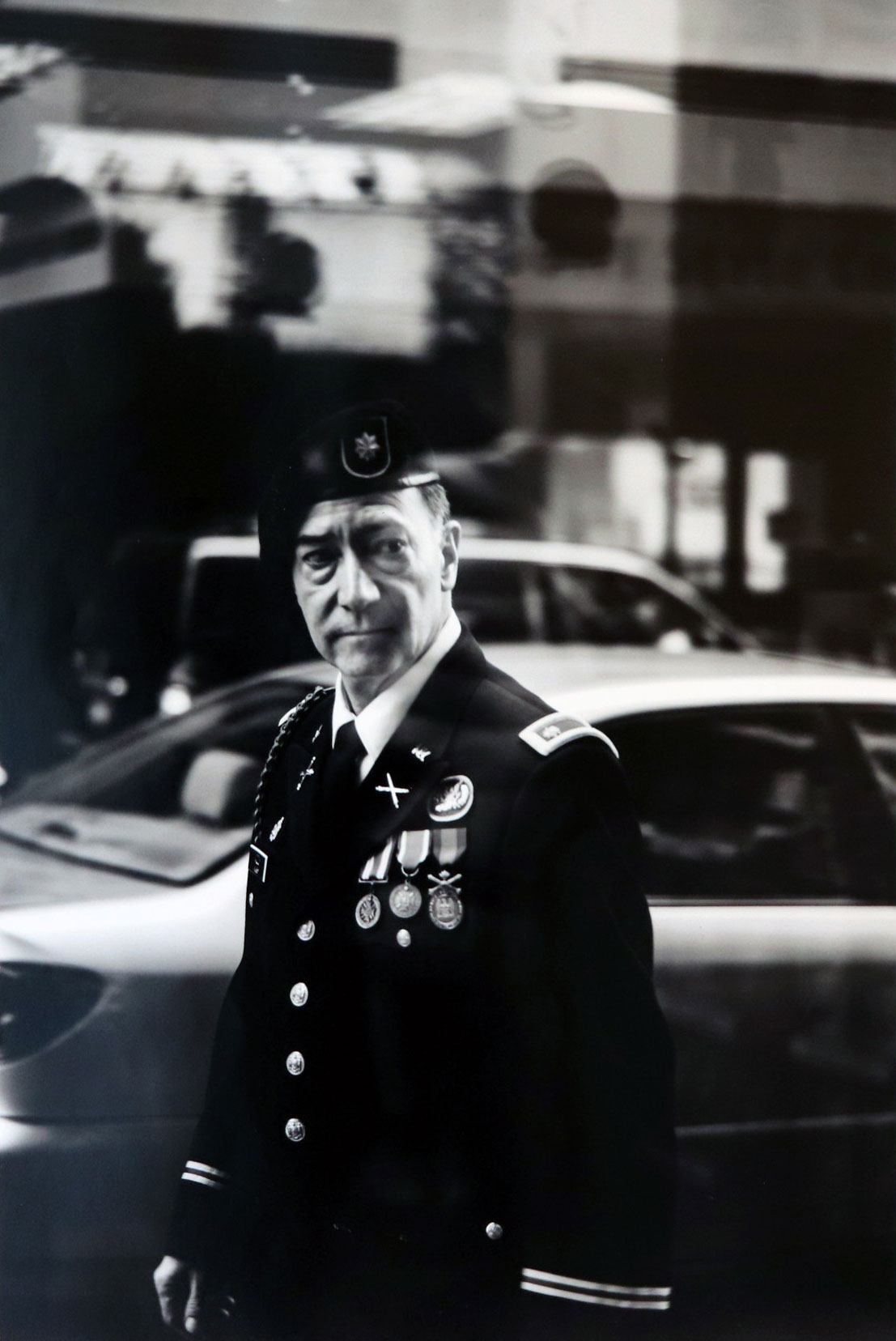 a photograph of a man in military attire on a city street
