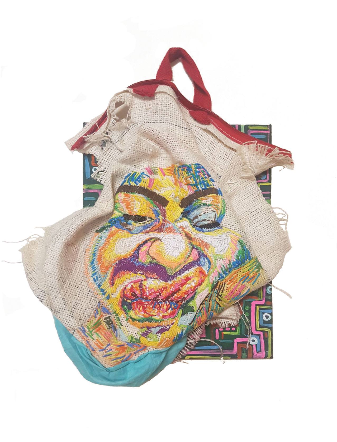 A tote bag with an embroidered face
