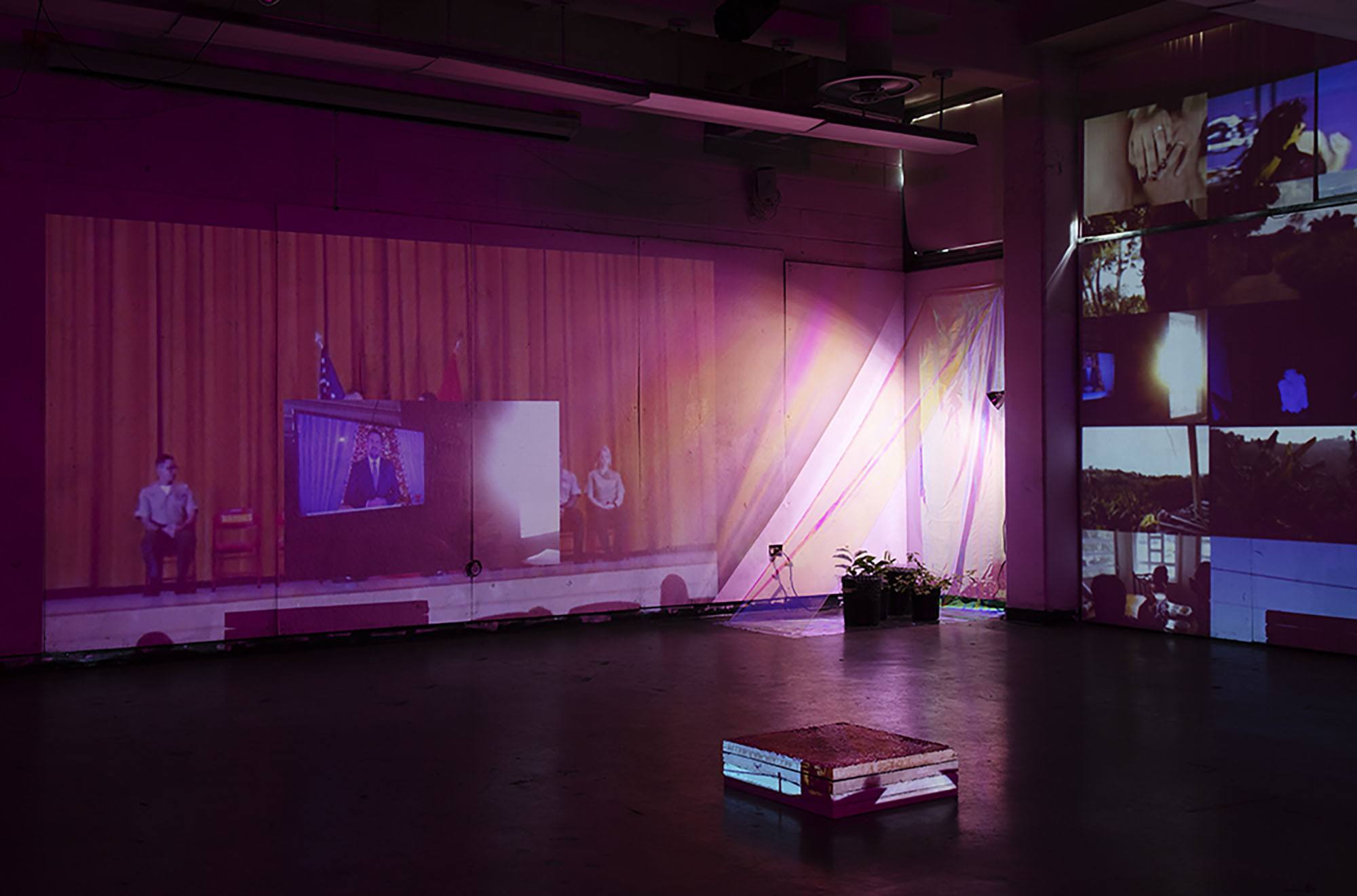 A gallery installation containing many projections