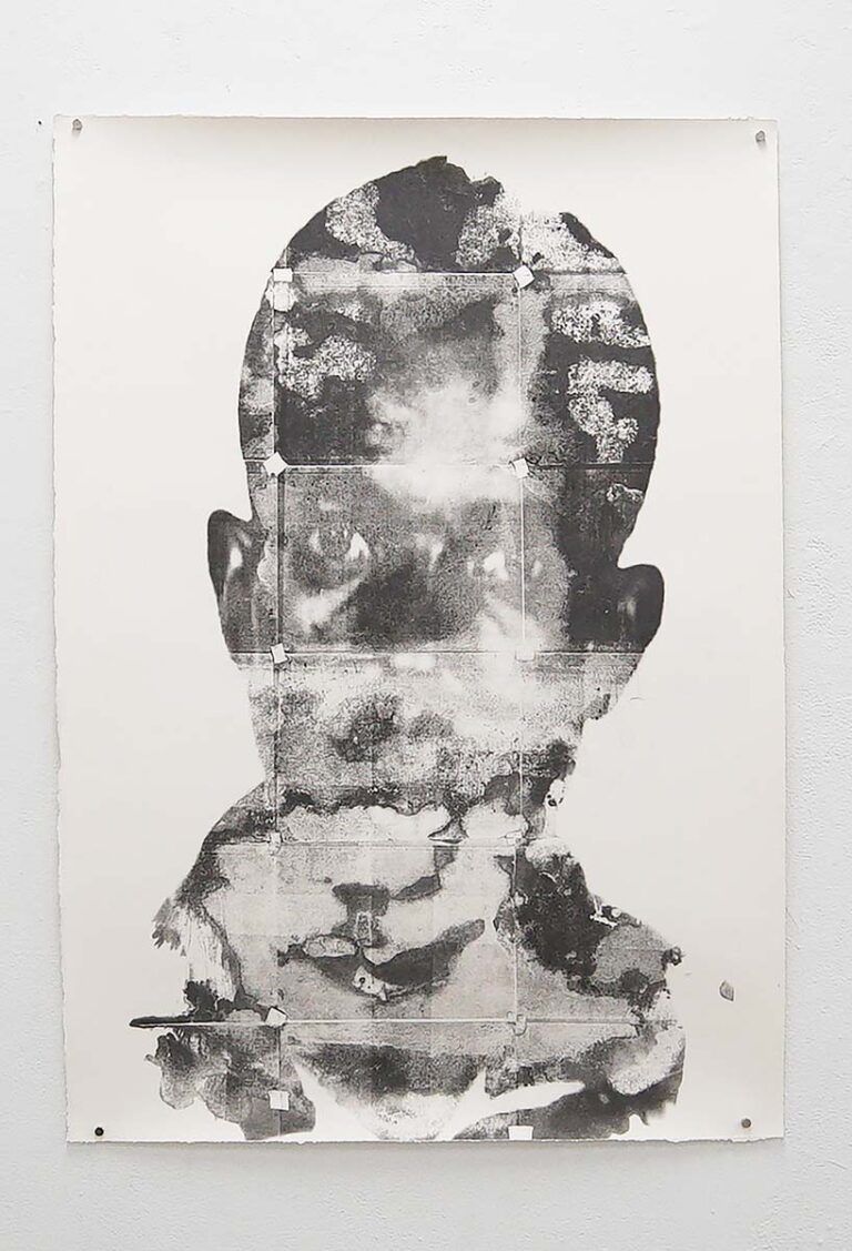 A print of a person partially obstructed by ink splatters