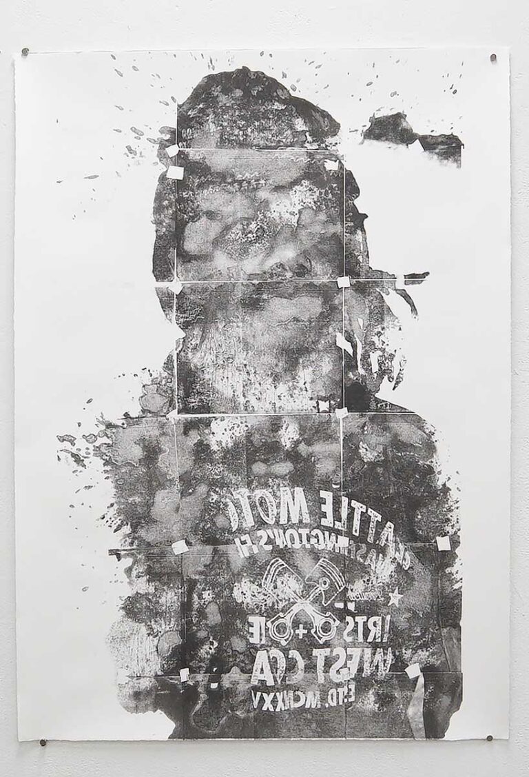 A print of a person that is partially obstructed by ink splatters
