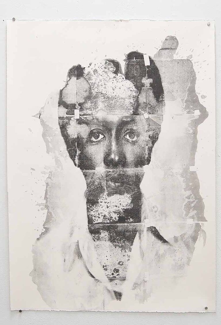 A print of a person with dark skin partially obstructed by ink splatters
