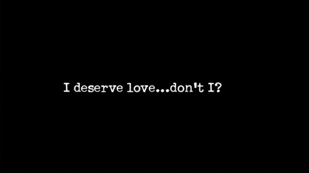 I black ground with white text reading "I deserve love...don't I?"