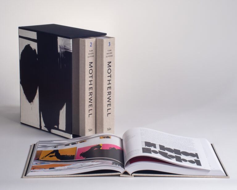 A box containing the volumes 2 and 3 of the Robert Motherwell Paintings Catalogue Raisonné with Volume laid open to a page