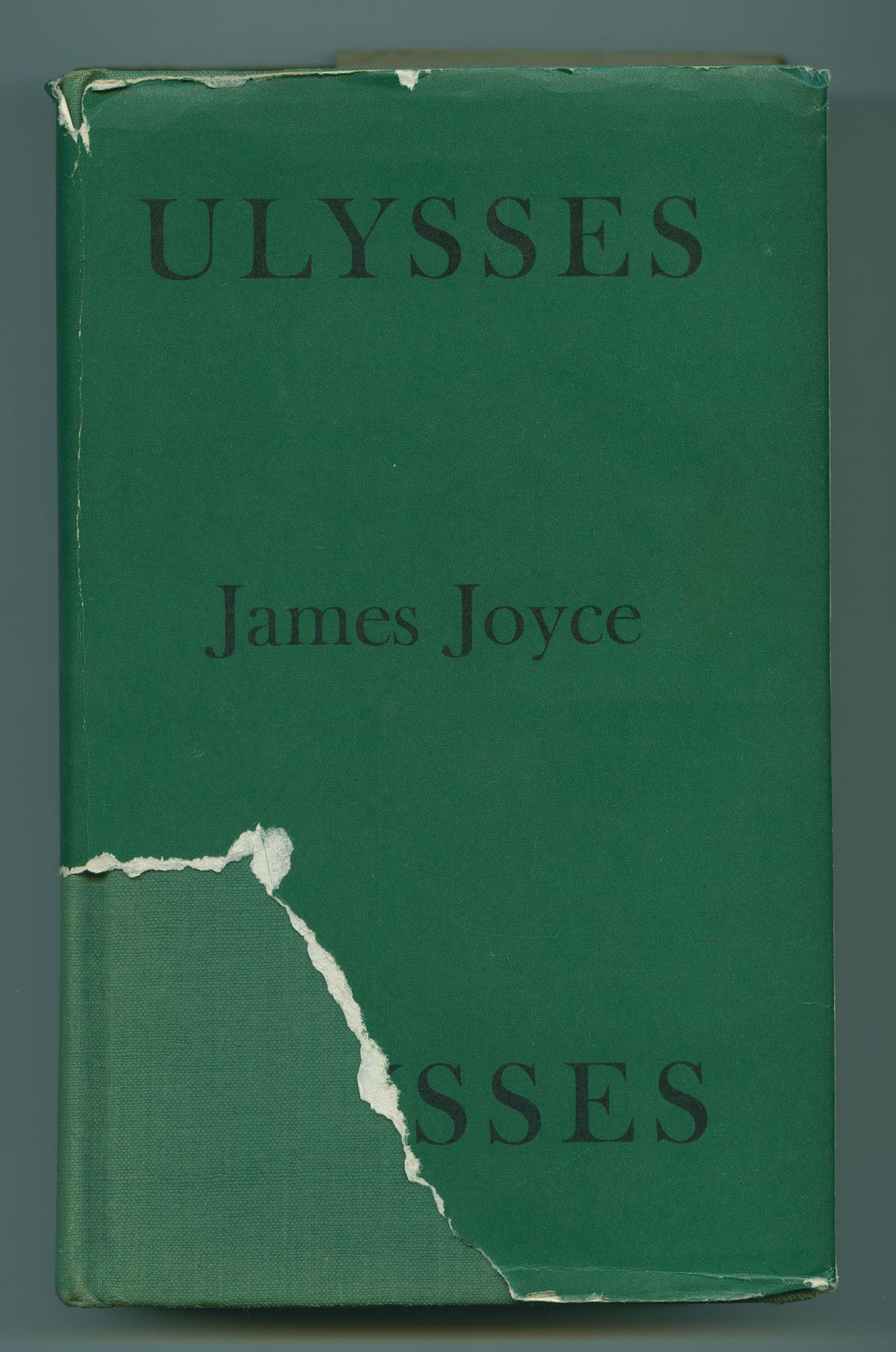 The cover of Ulysses partially torn, with black text on a green background