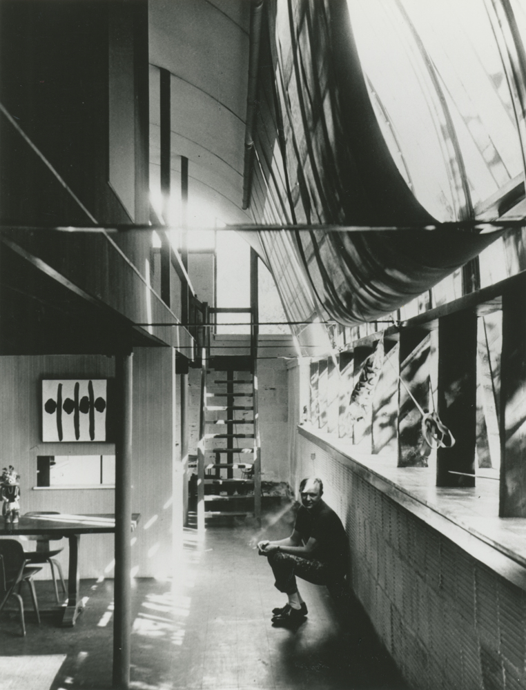Robert Motherwell seated in his Quonset house