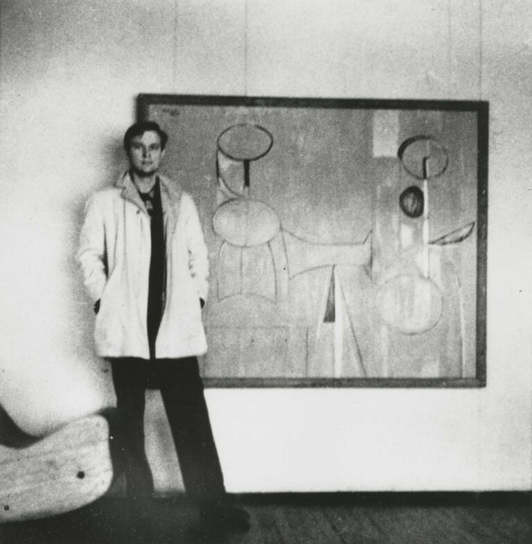 Robert Motherwell standing in front of one of his paintings at Art of this Century