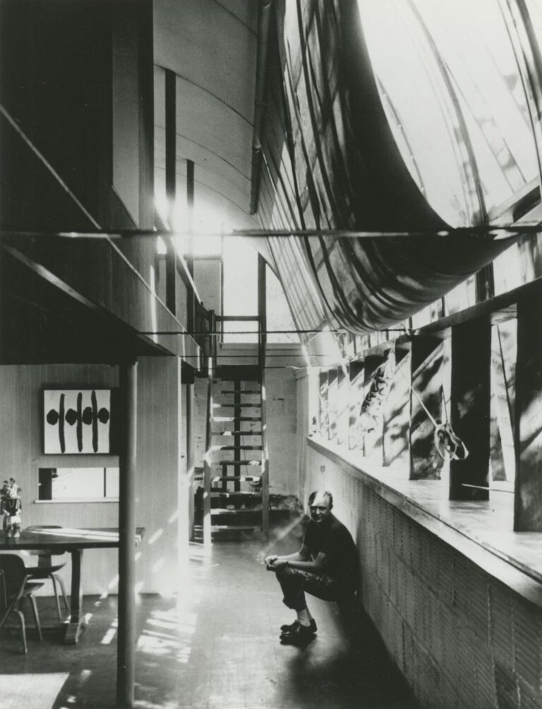 Robert Motherwell sitting near the window in his East Hampton Quonset hut studio