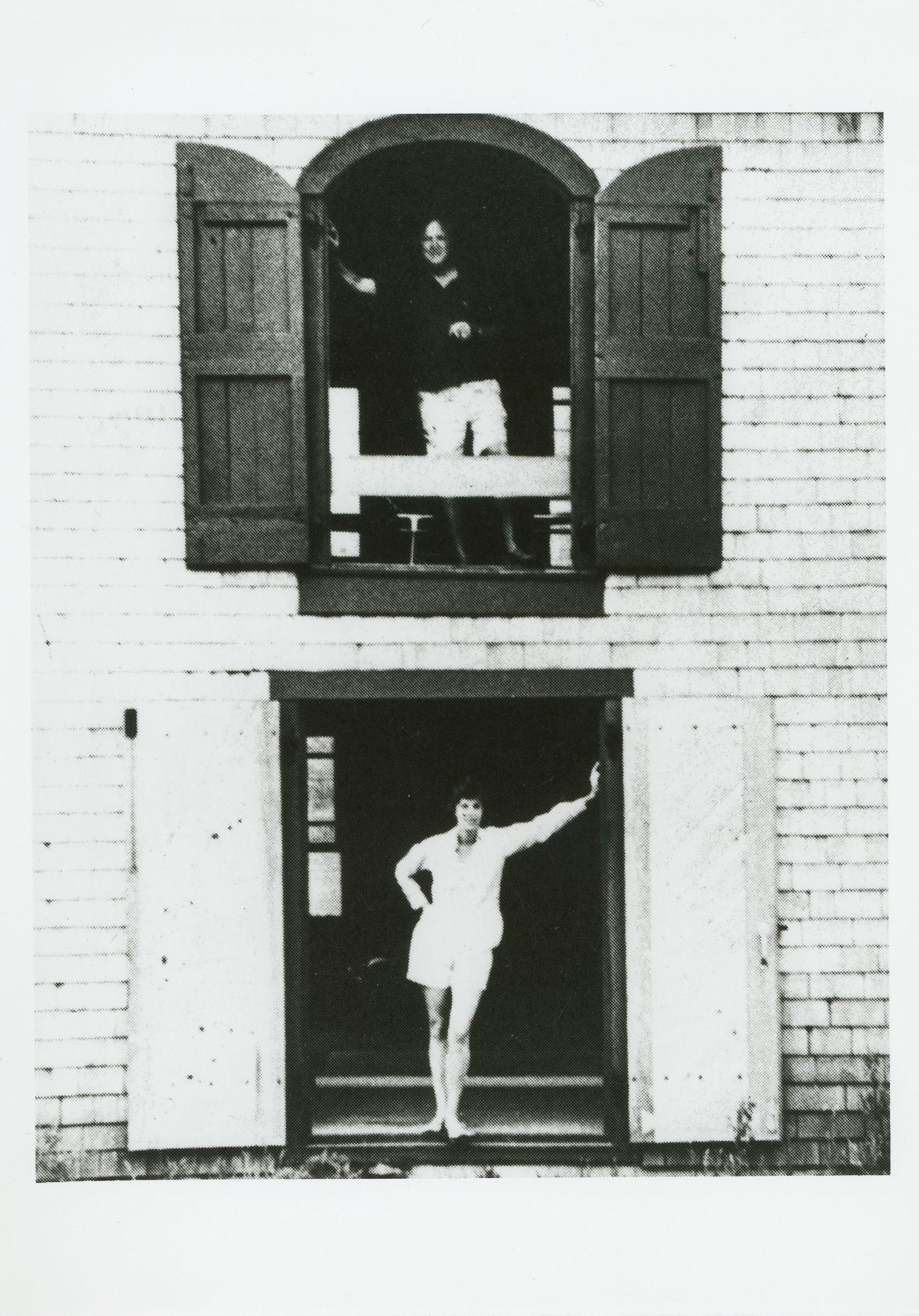 Motherwell and Helen Frankenthaler in large windows stacked on two stories of a large open building