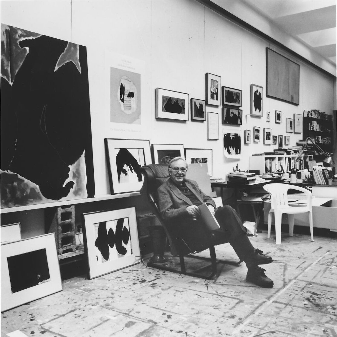 Robert Motherwell sitting in a chair in his studio