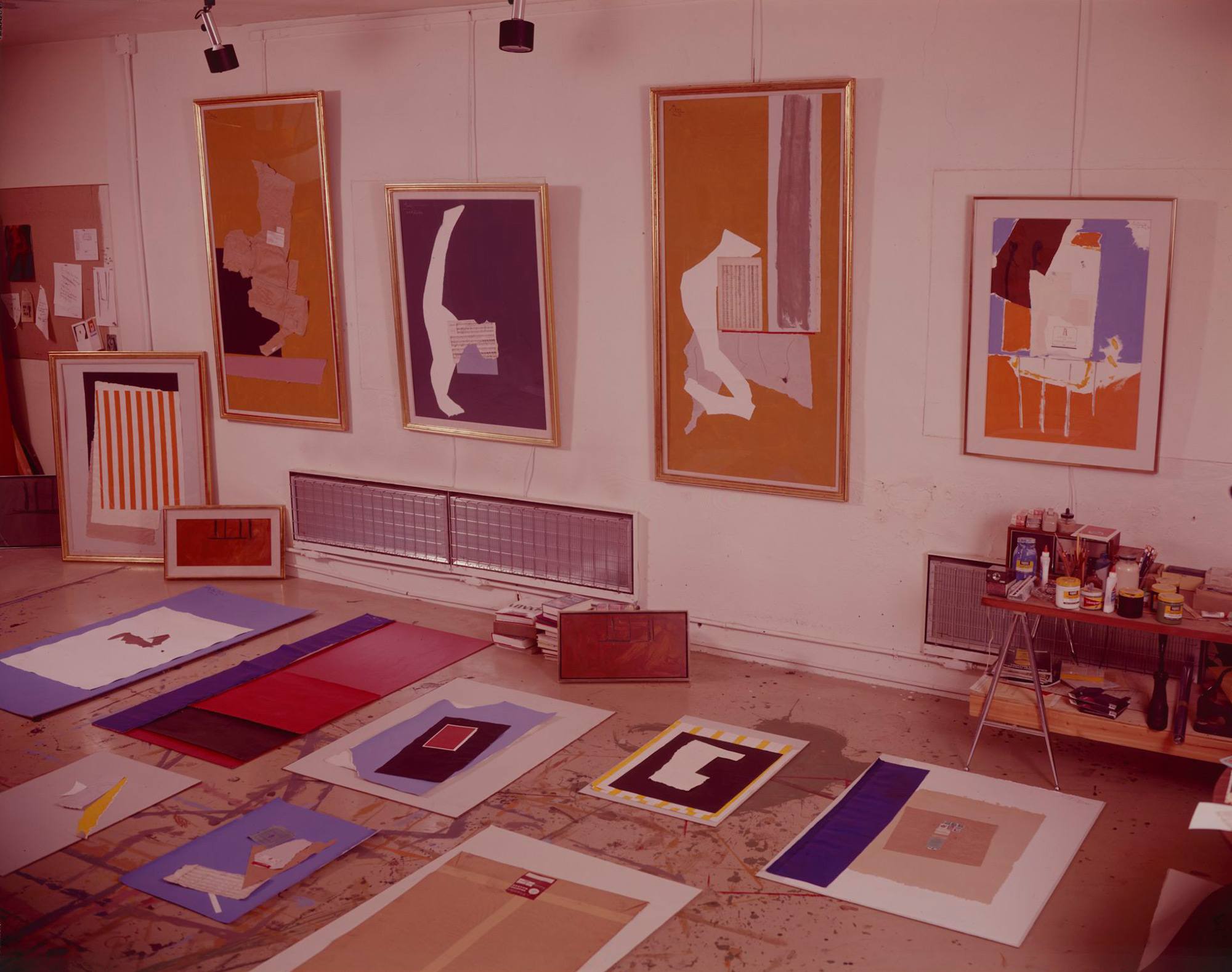 a group of collages on the floor and wall in Motherwell's studio