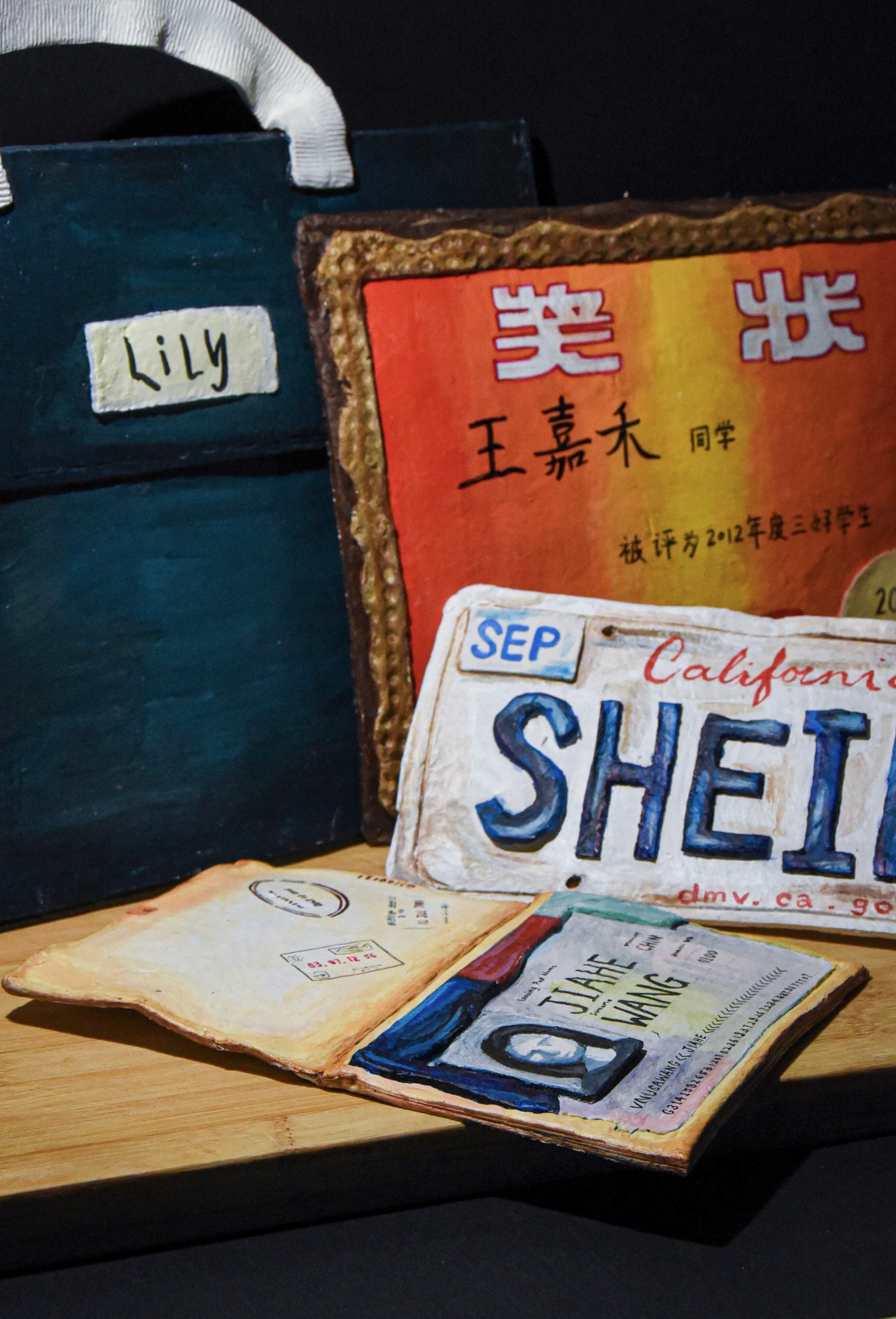 A painting of A painting of a bag labeled "Lily" with a California license plate and other items