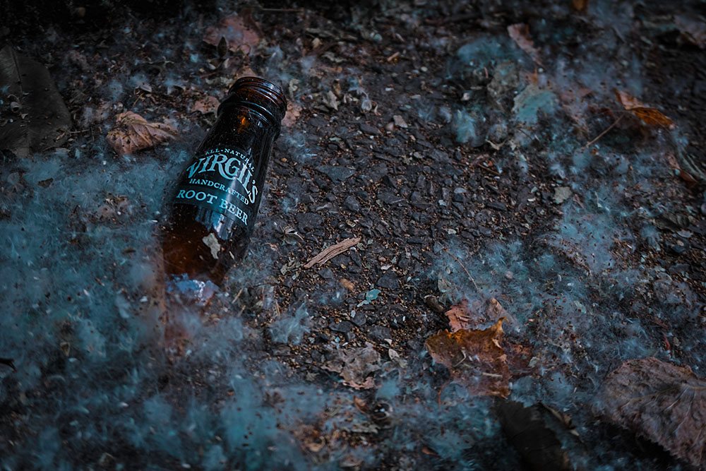 A cracked root beer bottle on the street