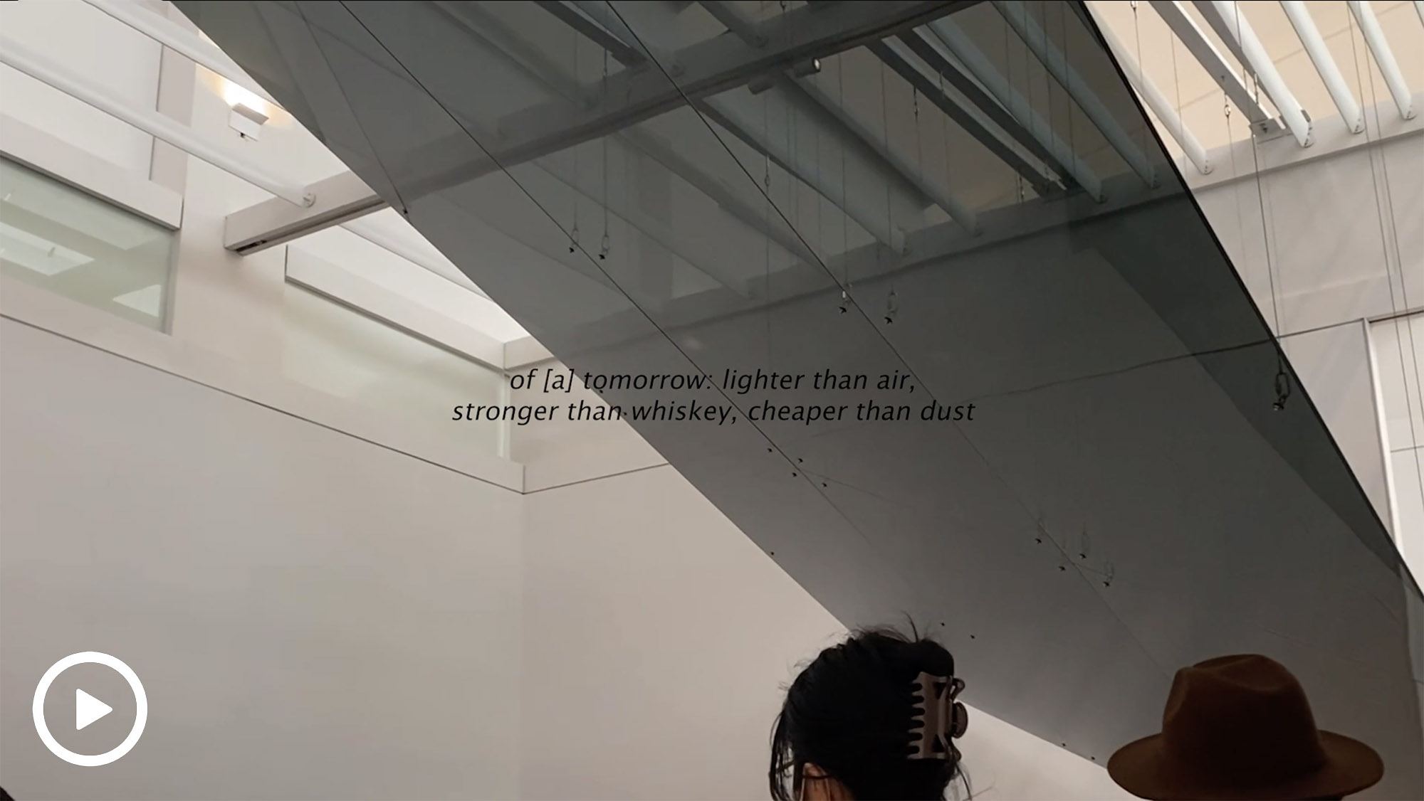 An installation image with text that says "of a tomorrow: lighter than air, stronger than whiskey, cheaper than dust"