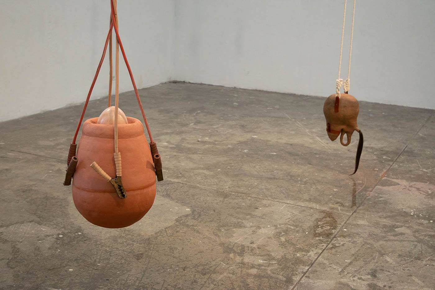 Suspended sculptures hanging in a gallery