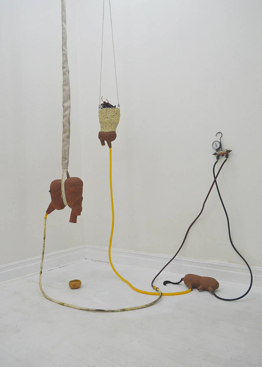 an installation of suspended and wall mounted sculptures